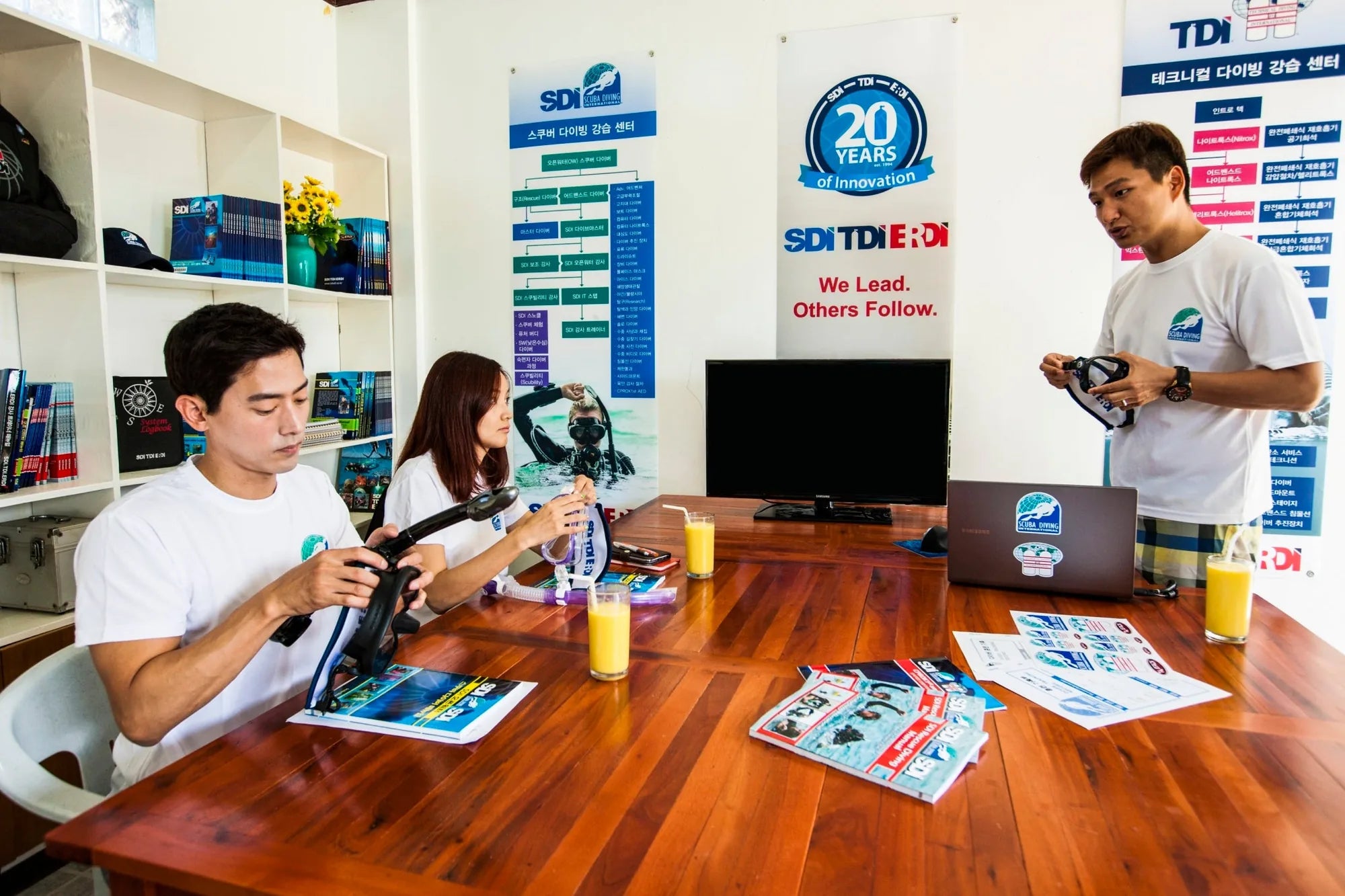Open water scuba diving instructor leading students